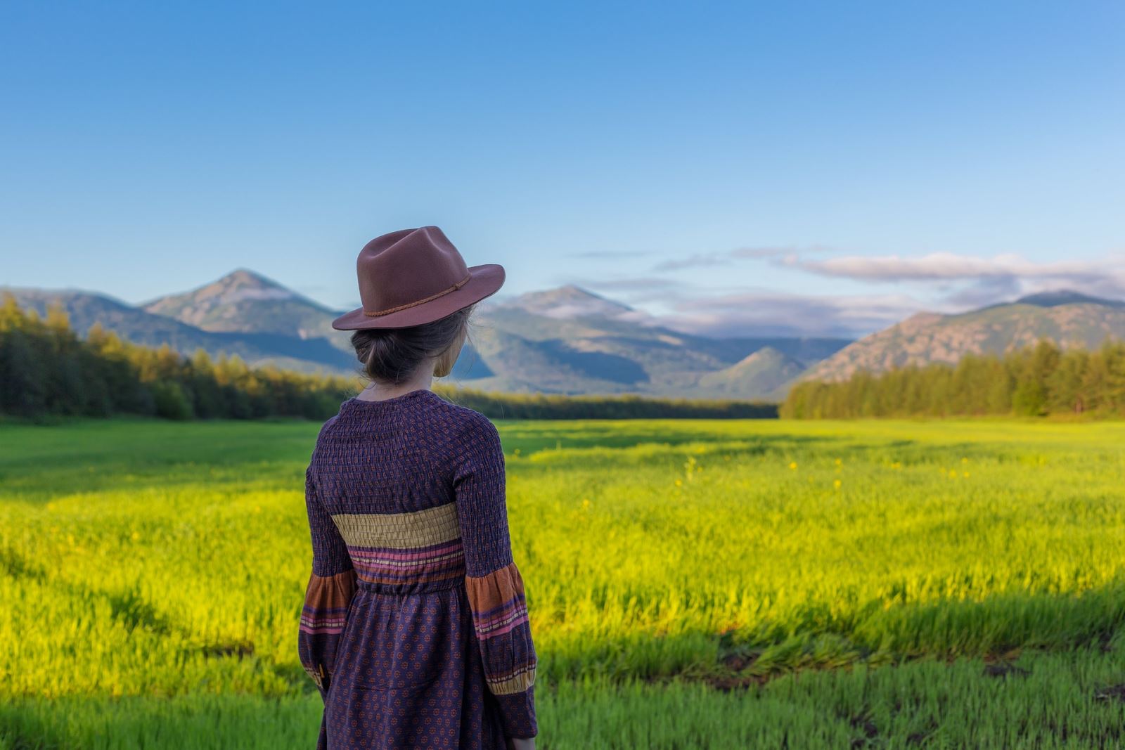 Girl looking out across a rural landscape
